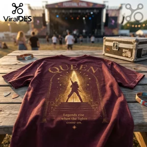 Maroon Queen band t-shirt with gold Freddie Mercury silhouette print, arched frame, and lyrics on a wooden picnic table.!