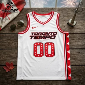 White Toronto Tempo basketball jersey with red trim, the number 00 featuring white maple leaf patterns on a wooden surface.!