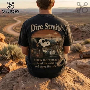 Black vintage-wash t-shirt featuring Snoopy wearing sunglasses, sitting on a vinyl record near a suitcase and desert road.!