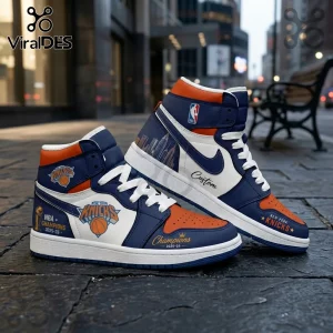 New York Knicks high-top sneakers in blue, orange, and white leather with 2025-26 championship graphics on a city street.!