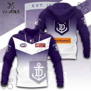 Fremantle Dockers AFL hoodie with purple and white gradient, team shield logo, and sponsor patches on light grey background.!