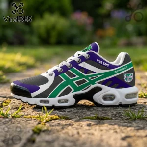 Custom Warriors athletic sneaker in purple, green, and grey with white laces and visible air cushioning on stone ground.!