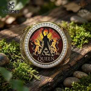 Gold ring featuring the Queen band logo with Freddie Mercury silhouette, red enamel, and pavé stones on mossy wood log.!