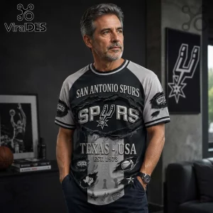 Man wearing San Antonio Spurs raglan t-shirt with ripped fabric graphics, team logos, and Texas USA text in black and grey.!