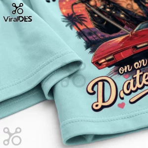 Light blue t-shirt with 1980s synthwave graphic, red sports car, palm trees, and text reading on on D.ate.!