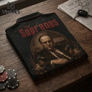 Black polo shirt featuring Tony Soprano graphic, Satriale's Pork Store sign, and ducks on a wooden table with poker chips.!
