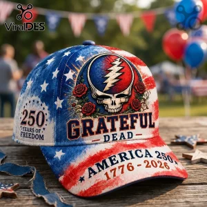 Grateful Dead America 250 baseball cap featuring a skull, lightning bolt, roses, and USA flag design on a wooden table.!