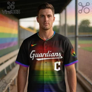Man wearing a black baseball jersey with rainbow gradient print, Guardians text, and a white C on a dugout background.!