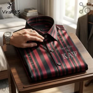 Kappa Alpha Psi striped dress shirt in burgundy and black with embroidered fraternity letters on a wooden table.!