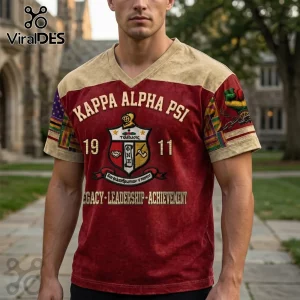 Kappa Alpha Psi crimson v-neck shirt featuring Greek lettering, fraternity crest, and Legacy Leadership Achievement text.!