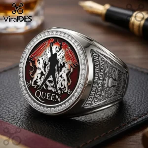 Silver Queen band championship ring with a maroon crest, winged figure, and engraved side text Freddie Mercury Champion.!