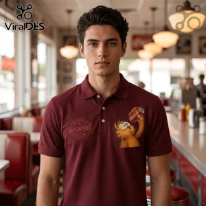 Man wearing a maroon polo shirt featuring a graphic of Garfield holding a Coca-Cola can and Anti-Monday Club text.!