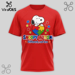 Red cotton crew neck t-shirt featuring Snoopy holding a multi-colored puzzle heart with text reading Snoopy Autism.!