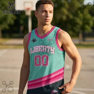 Man wearing turquoise and pink Liberty basketball jersey with number 00, breast cancer awareness ribbons, and logo on court.!