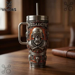 Megadeth stainless steel tumbler featuring a relief skull, Vic Rattlehead imagery, and orange filigree on a wooden desk.!