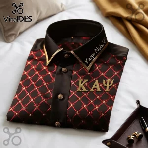 Black dress shirt with red diamond pattern, gold trim, and gold Kappa Alpha Psi Greek letters on a white bed sheet.!
