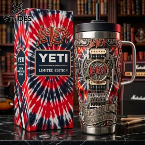 Slayer branded metal tumbler with guitar neck and hardware design next to a red, white, and blue tie-dye patterned box.!