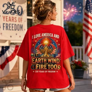 Woman wearing red t-shirt with patriotic pyramid graphic, American flag, disco ball, and Earth Wind and Fire text print.!