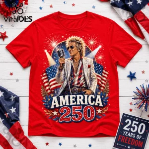 Red graphic t-shirt featuring Rod Stewart holding a microphone, US flag, fireworks, and text America 250 on white wood.!