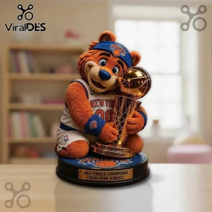 New York Knicks mascot figure wearing a jersey and headband, holding a gold NBA championship trophy on a circular base.!