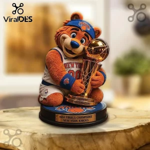New York Knicks mascot figure wearing a blue headband and team jersey while holding a gold Larry O'Brien trophy on a base.!