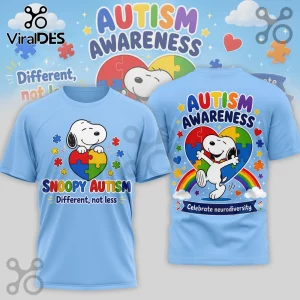 Light blue t-shirt featuring Snoopy, puzzle piece hearts, rainbows, and the text Autism Awareness and Different, not less.!
