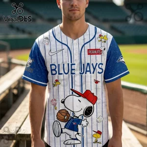 Toronto Blue Jays baseball jersey with white pinstripes and Snoopy cartoon graphics against a stadium background.!