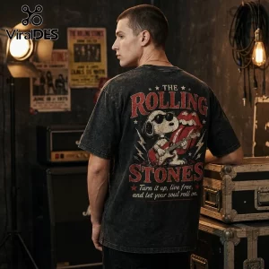 Acid-wash black t-shirt featuring Snoopy playing guitar with The Rolling Stones tongue logo and vintage concert posters.!