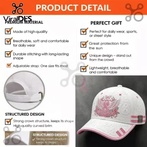 White baseball cap with embroidered pink ribbon, floral details, and Breast Cancer Awareness text on a dark background.!