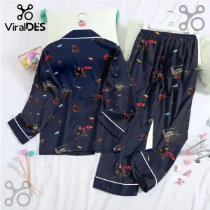 Navy blue button-down pajama set featuring Harry Potter flying on a broomstick, golden snitches, and vintage trunks.!