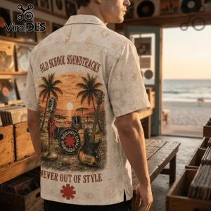 Man wearing a cream button-down shirt with Red Hot Chili Peppers graphic, palm trees, beach scene, and musical instruments.!