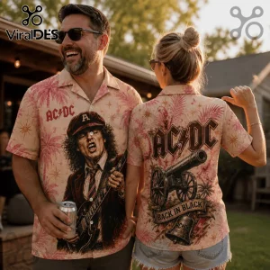 Man and woman wearing beige button-down shirts featuring AC/DC prints, Angus Young guitar graphics, and palm tree motifs.!