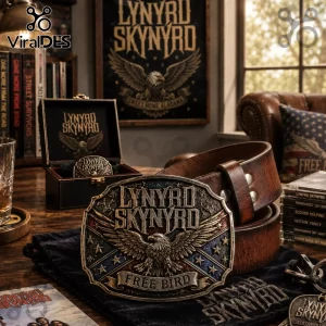 Lynyrd Skynyrd metal belt buckle with eagle emblem and Free Bird text on brown leather belt atop a black velvet bag.!