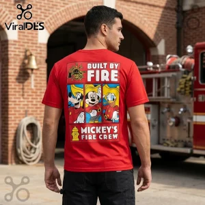Man wearing a red t-shirt with Disney cartoon firefighter graphic reading Built By Fire and Mickey’s Fire Crew.!