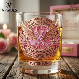 Clear glass whiskey tumbler with rose gold metal emblem featuring breast cancer awareness ribbon, wings, and 2026 date.!
