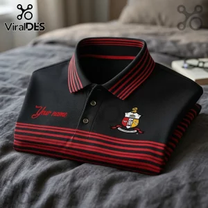 Black polo shirt with red horizontal stripes on the hem and collar featuring a custom crest and name embroidery.!
