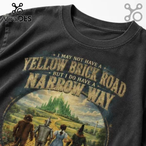 Faded black vintage-style t-shirt featuring Wizard of Oz characters with text: I MAY NOT HAVE A YELLOW BRICK ROAD.!