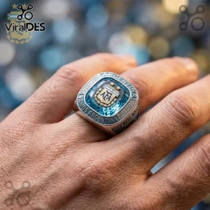 Argentina football championship style ring with central blue gemstone, gold AFA crest, and text Vamos Argentina.!