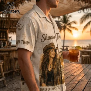 Man wearing a cream button-down shirt with seashells, Shania Twain text, and a leopard print cowboy hat graphic design.!