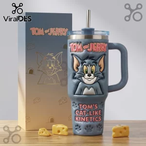 Blue Tom and Jerry insulated tumbler with 3D embossed Tom face and text Tom's Cat-Like Kinetics on wooden surface.!