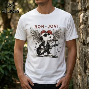 White crew neck t-shirt featuring Snoopy wearing sunglasses and a leather jacket playing a guitar with wings above.!