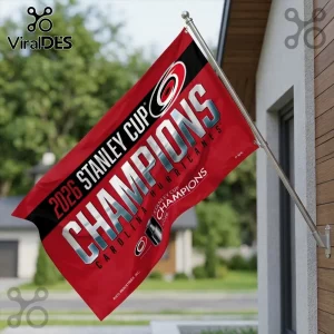 Carolina Hurricanes 2026 Stanley Cup Champions red fabric flag mounted on a silver pole against a blurred house background.!