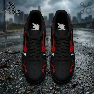 Black sneakers featuring red claw marks, white Godzilla silhouettes on insoles, and white Japanese text on wet pavement.!