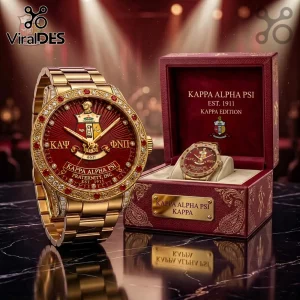 Gold-tone Kappa Alpha Psi watch with red dial, diamond-encrusted bezel, and branded crimson display box on marble table.!