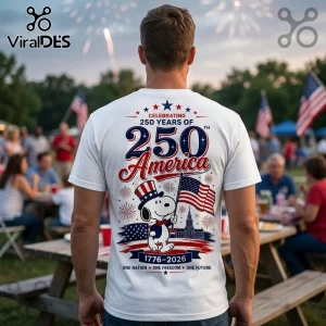 White t-shirt showing Snoopy in a top hat holding a US flag with text Celebrating 250 Years of America 1776-2026.!