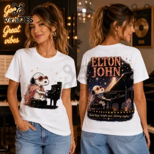 White cotton crewneck t-shirt featuring Snoopy dressed as Elton John playing a grand piano on front and back graphic.!