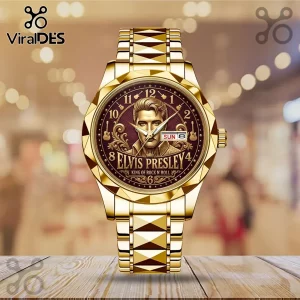 Gold-toned metal wristwatch featuring a portrait of Elvis Presley and text reading King of Rock N Roll on a dark dial.!