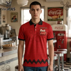 Man wearing red polo with black grid pattern, Snoopy on Coca-Cola crate graphic, and text Custom Name on chest.!