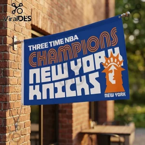 Blue New York Knicks banner on a brick wall featuring orange text and a Statue of Liberty icon with white lettering.!