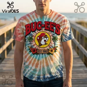 Buc-ee's logo graphic t-shirt on tie-dye fabric featuring a beaver mascot, palm trees, hibiscus flowers, and Est. 1982 text.!